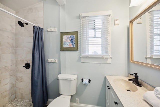 bathroom with a shower with curtain, vanity, a healthy amount of sunlight, and toilet