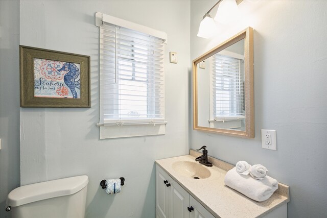 bathroom featuring vanity and toilet