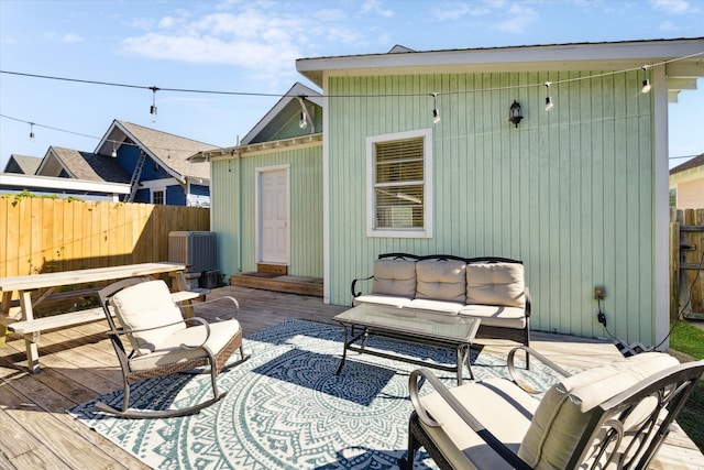 wooden terrace with central air condition unit and an outdoor living space