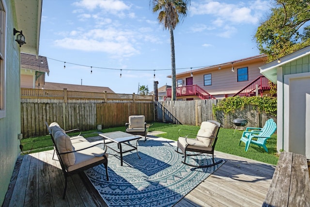 wooden deck featuring an outdoor living space and a yard