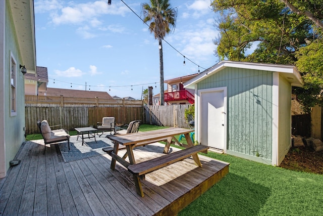 deck featuring outdoor lounge area, a storage unit, and a lawn