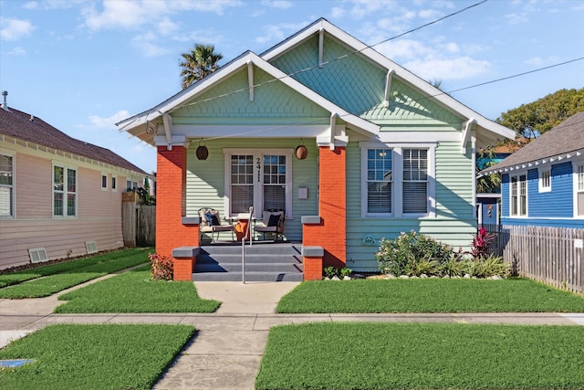 bungalow-style house with covered porch and a front yard