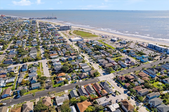 birds eye view of property with a water view and a view of the beach