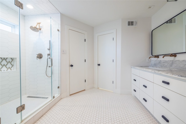 bathroom with vanity and a shower with door