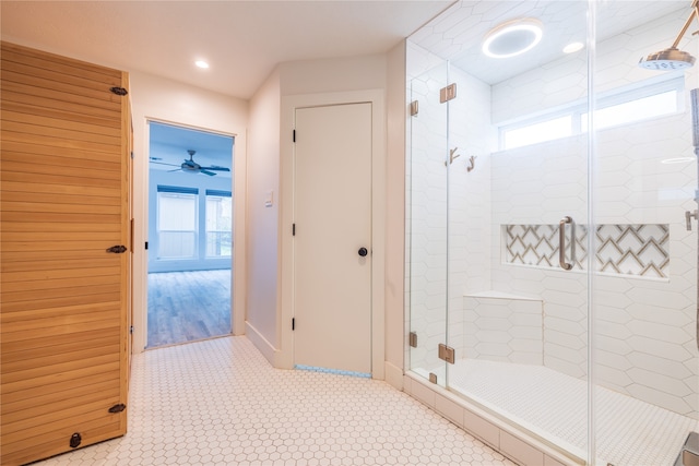 bathroom with ceiling fan and a shower with shower door