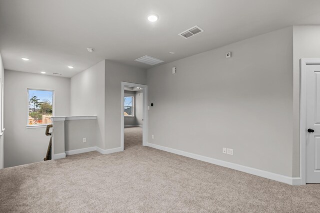 unfurnished room featuring light colored carpet