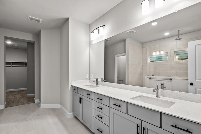 bathroom featuring a shower, vanity, and tile patterned floors