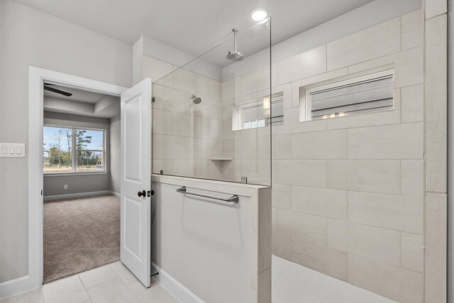 bathroom featuring tiled shower and tile patterned floors