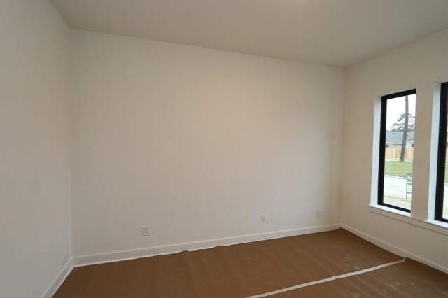 spare room with wood-type flooring