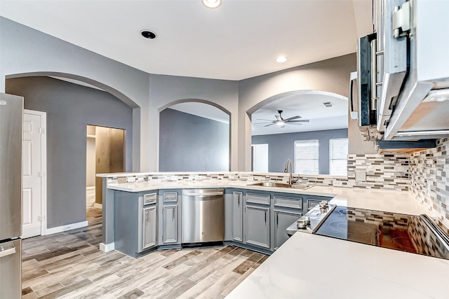 kitchen featuring gray cabinetry, ceiling fan, sink, light hardwood / wood-style flooring, and appliances with stainless steel finishes