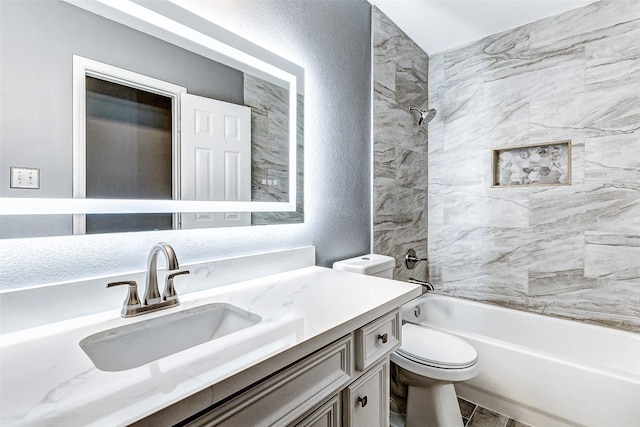 full bathroom with vanity, toilet, and tiled shower / bath