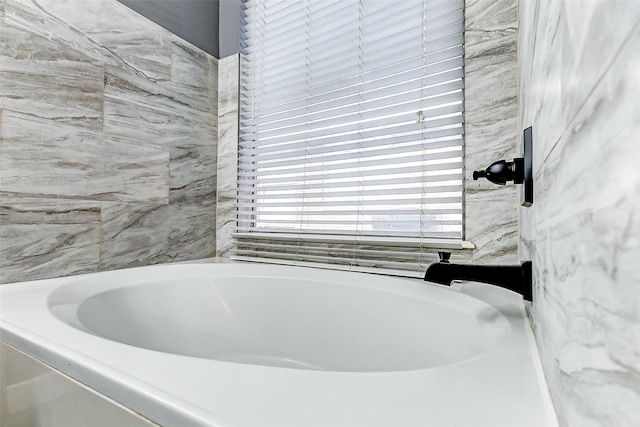 bathroom with a tub to relax in