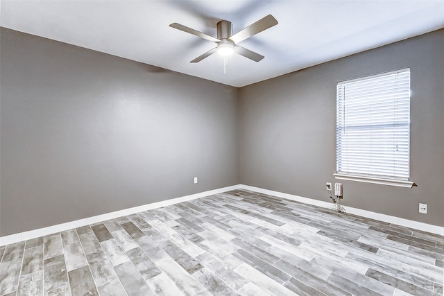 unfurnished room with ceiling fan and light hardwood / wood-style flooring