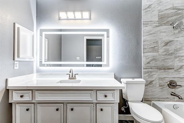 full bathroom featuring vanity, tiled shower / bath combo, and toilet