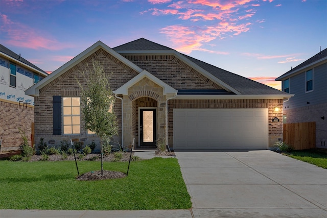 view of front of property with a lawn and a garage