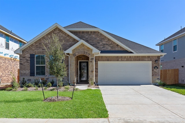 view of front of house featuring a front yard and a garage