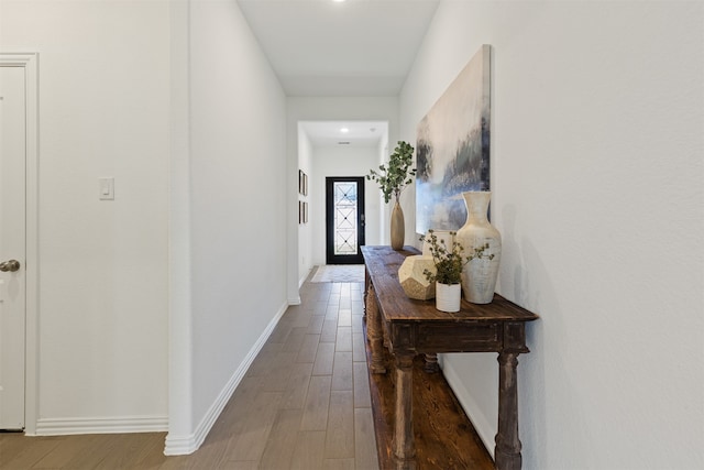 corridor with hardwood / wood-style floors