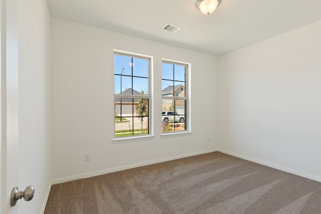 spare room featuring carpet