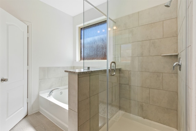 bathroom featuring shower with separate bathtub