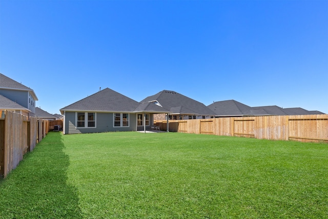 rear view of house featuring a yard