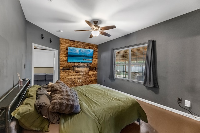 bedroom with ceiling fan, a walk in closet, and a closet