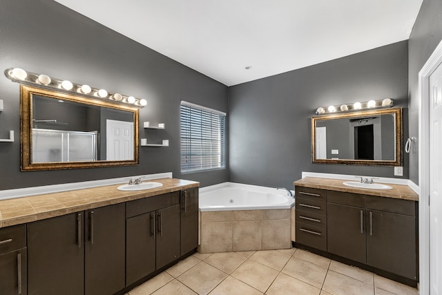 bathroom featuring tile patterned flooring, shower with separate bathtub, and vanity