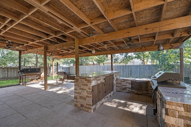 view of patio with ceiling fan and an outdoor kitchen