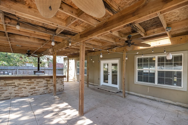 view of patio / terrace featuring ceiling fan, french doors, and an outdoor bar