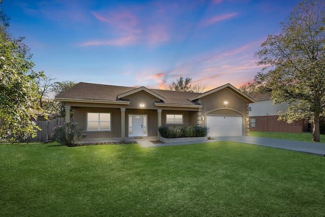 view of front of property with a lawn and a garage