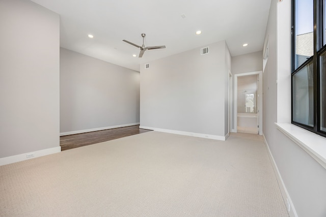 carpeted empty room featuring ceiling fan