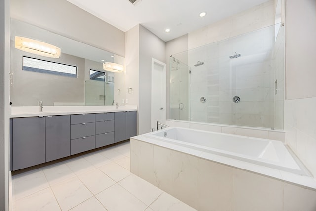 bathroom with tile patterned floors, vanity, and separate shower and tub