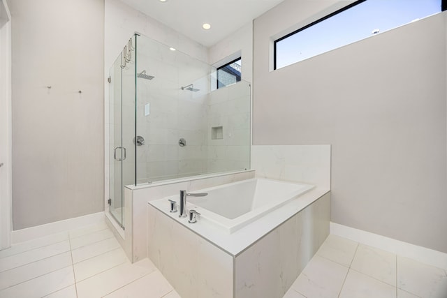 bathroom featuring tile patterned floors and independent shower and bath