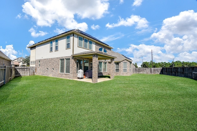 back of property featuring a patio area and a yard