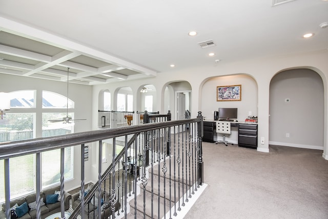 corridor featuring carpet flooring, beam ceiling, and coffered ceiling