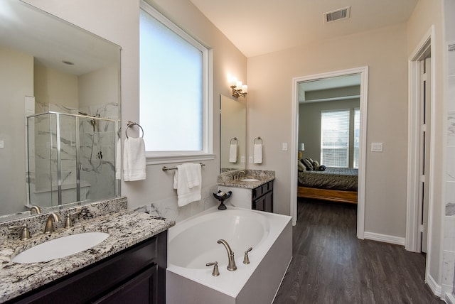 bathroom featuring hardwood / wood-style flooring, vanity, and independent shower and bath