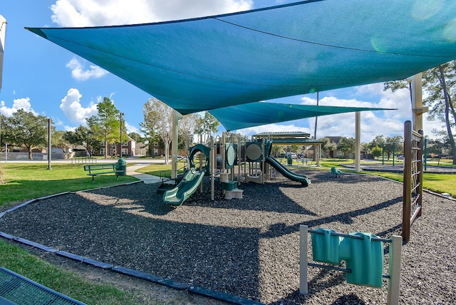 view of playground with a lawn