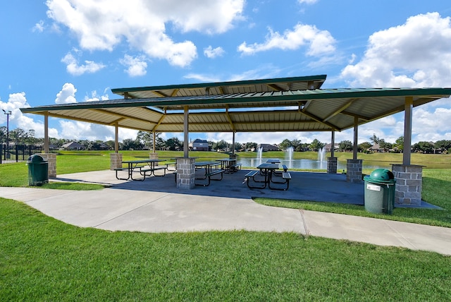 surrounding community featuring a gazebo, a water view, and a lawn