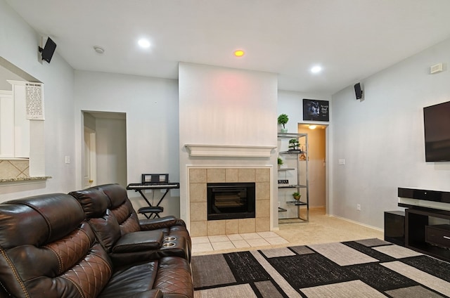 carpeted living room with a tile fireplace