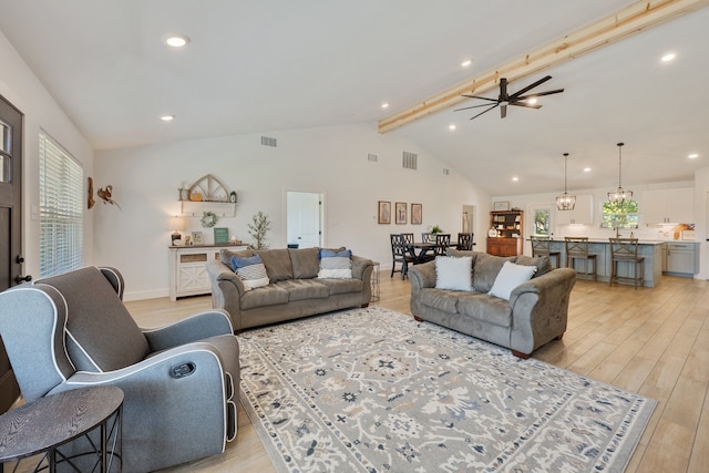 living room featuring beamed ceiling, high vaulted ceiling, light hardwood / wood-style flooring, and ceiling fan