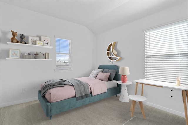 bedroom with light colored carpet, vaulted ceiling, and multiple windows