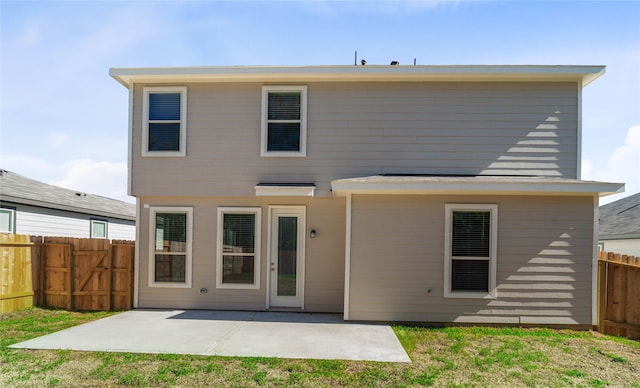 rear view of house with a patio area and a yard