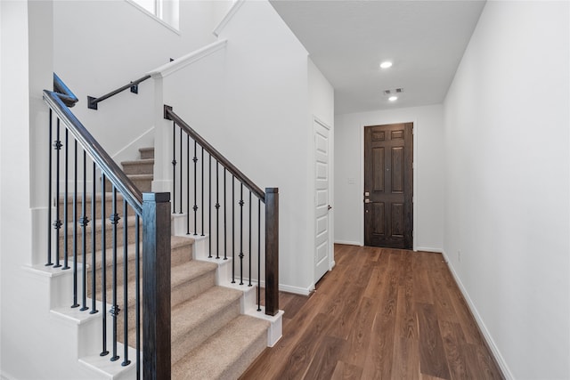 foyer entrance with dark wood-type flooring