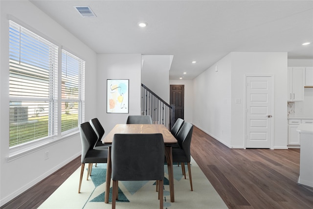 dining space with dark hardwood / wood-style floors