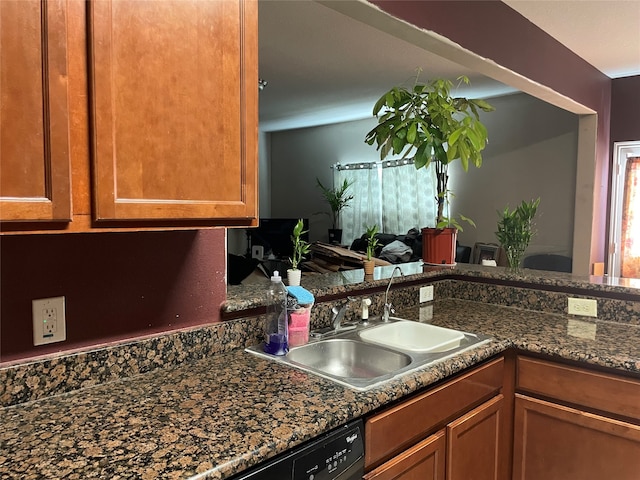 kitchen with dark stone counters and sink