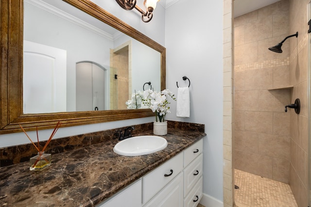 bathroom featuring crown molding, vanity, and tiled shower