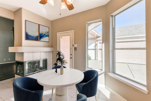 tiled dining space with ceiling fan