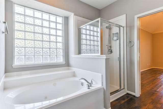 bathroom featuring shower with separate bathtub and wood-type flooring