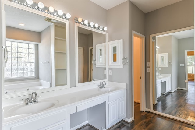 bathroom featuring hardwood / wood-style flooring, vanity, and a bathtub