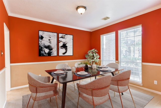 carpeted dining area featuring crown molding and a wealth of natural light