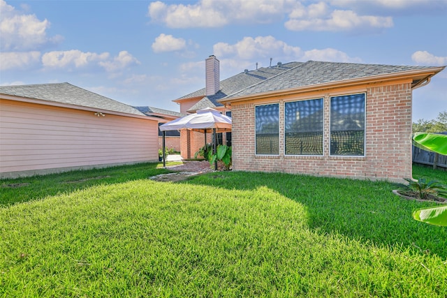 back of house featuring a yard